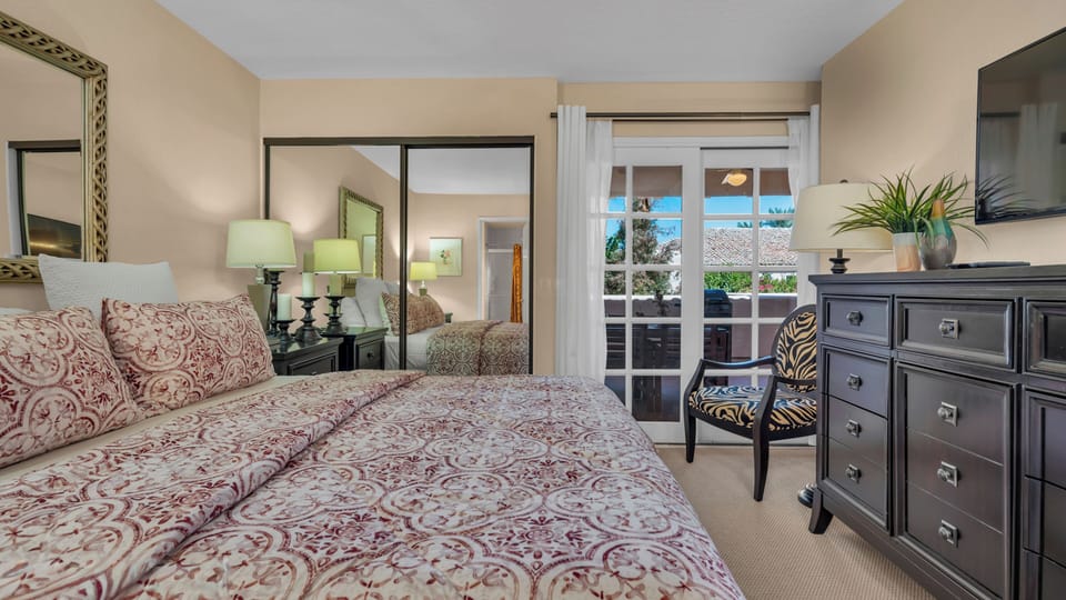 bedroom with French doors leading to the private patio/comfortable reading area