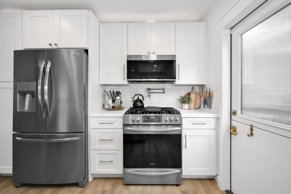 Fully stocked kitchen with microwave, dishwasher and Nespresso coffee maker.