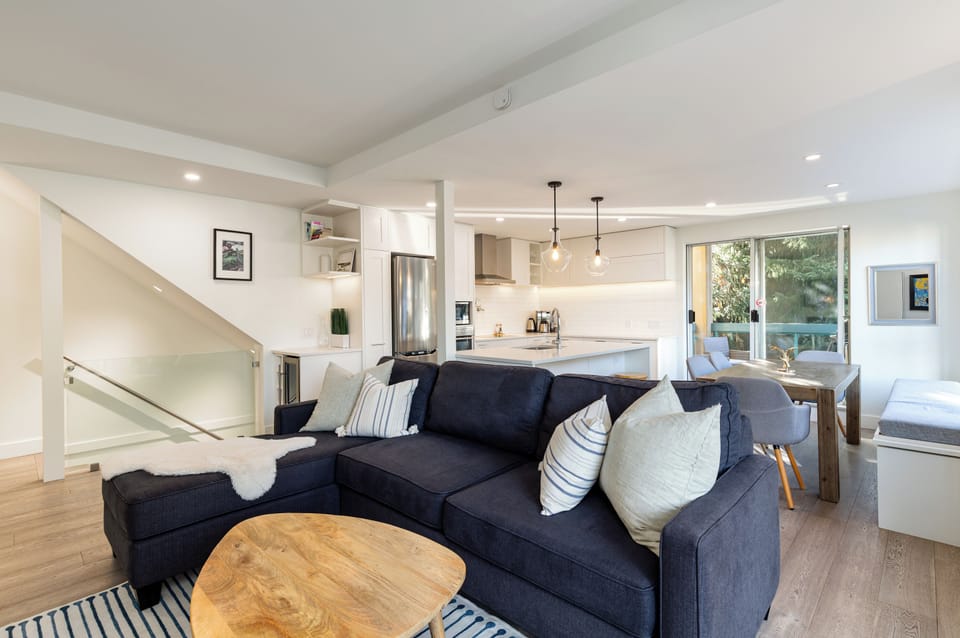 Living Room - Large comfortable couch, two patios, large SmartTV with cable, cozy fireplace, modern open and spacious floorplan.