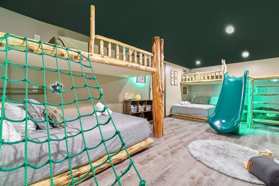 A kid’s dream come true! A bedroom with its own slide and climbing net