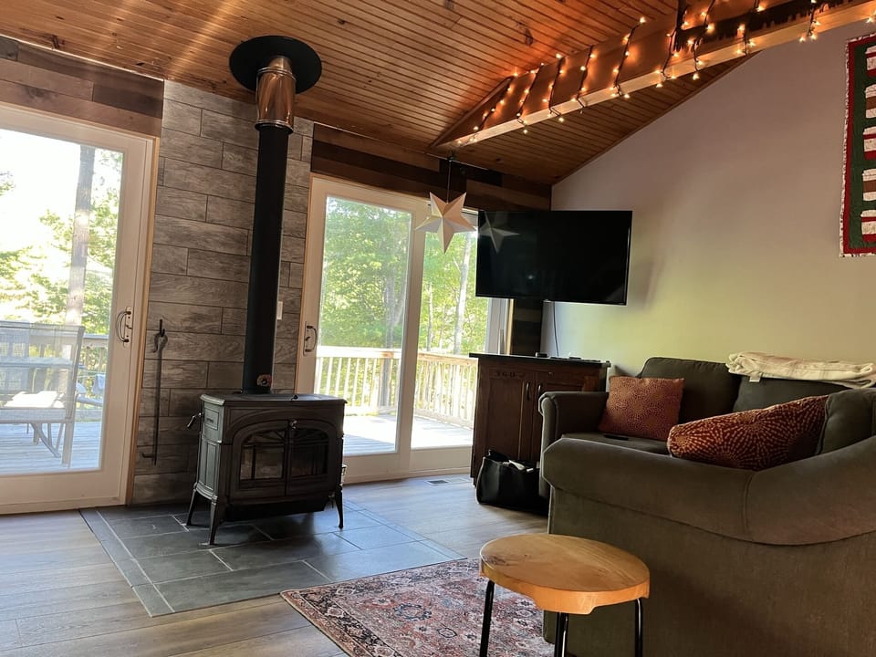 Living room opens directly to a wrap-around deck