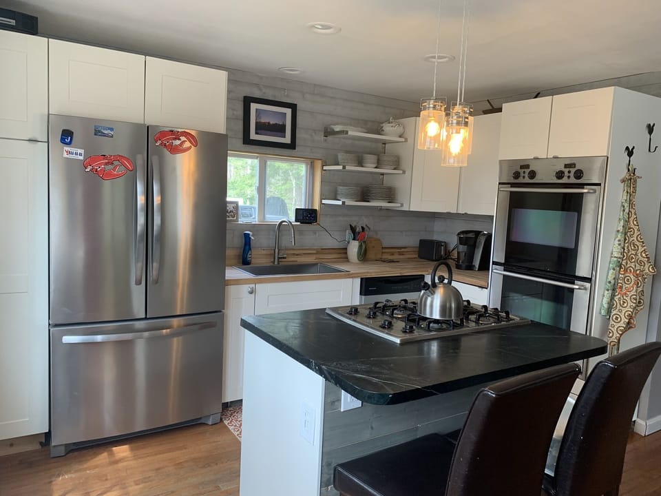 Updated kitchen with double oven, butcher block countertops and gas range