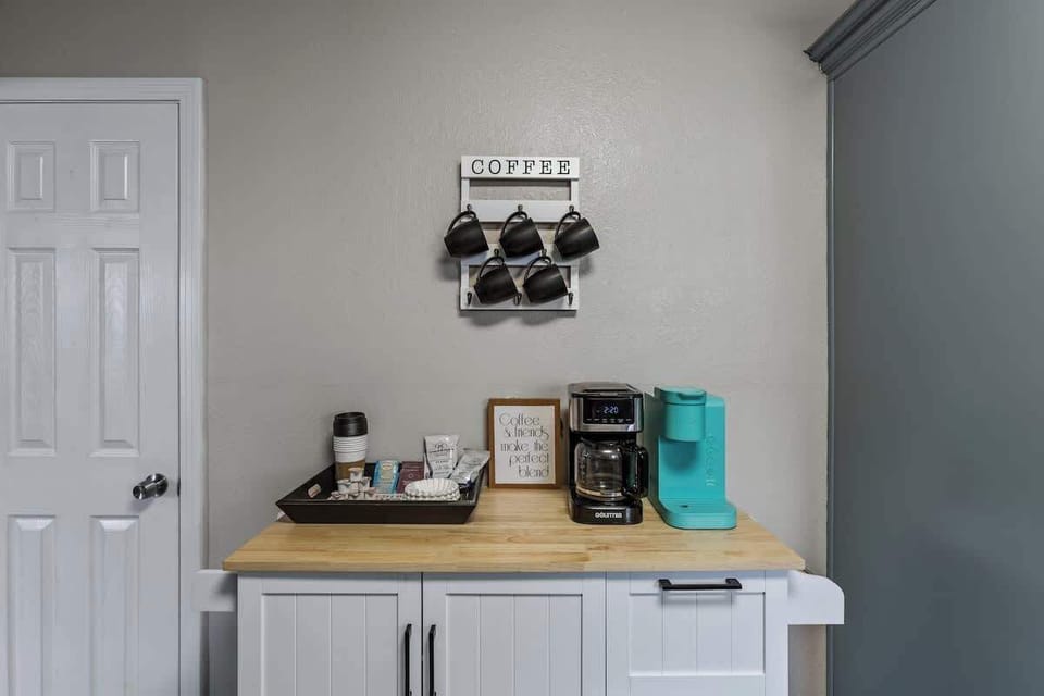 All the essentials for you coffee lovers.  A single-serve option and a full pot option with all the fixins'. The cabinet underneath has wine glasses and other bar cart essentials.
