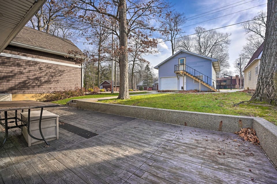 [Front Patio] Large umbrella and bench table are here during the warm weather.