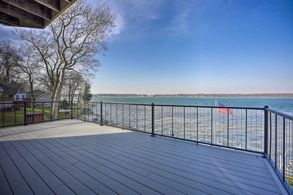 [Spacious Upper Deck] Patio table, chairs and umbrella are located here during the warm weather.