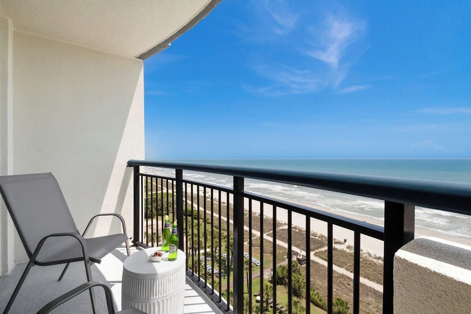 Step out onto your private balcony and soak in panoramic ocean views. With comfortable seating and a side table perfect for snacks or drinks, this serene spot invites you to unwind and enjoy the gentle sea breeze and the calming sound of the waves.