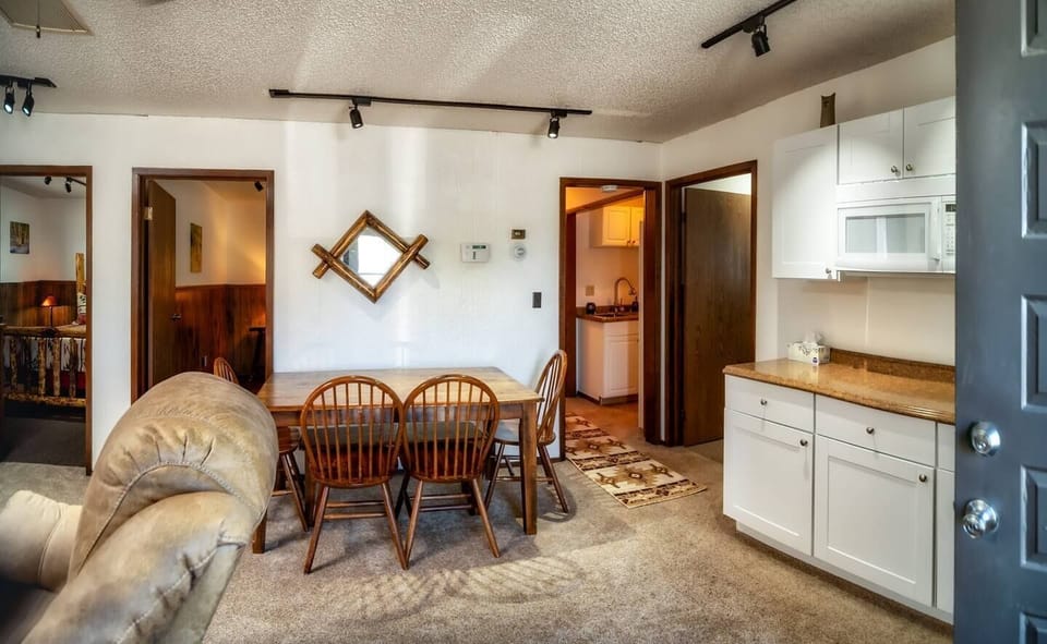 Kitchen table: 4 chairs and a bench. It can be moved away from the wall to utilize the bench for more seating.