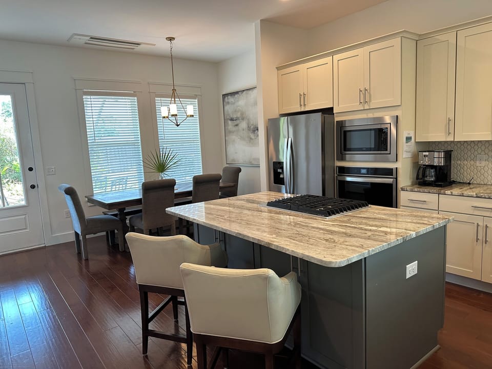 Kitchen seats six people at table and two people at kitchen island