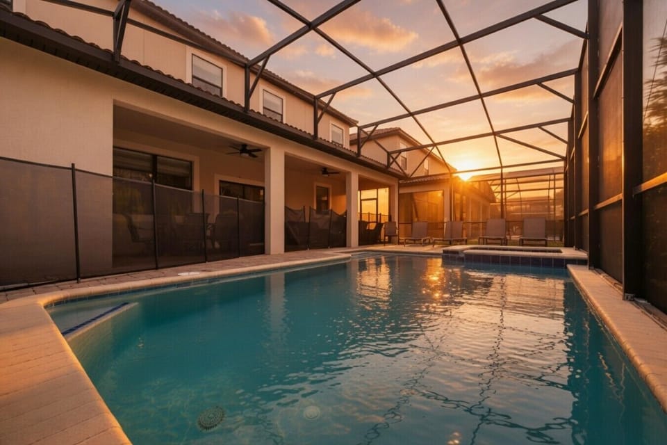 Private pool at sunset under screened enclosure