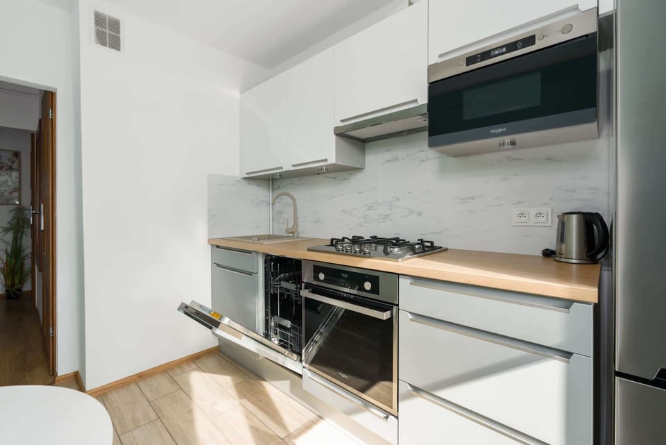 Another perspective of the kitchen, featuring built-in appliances, a gas stove, and ample counter space.
