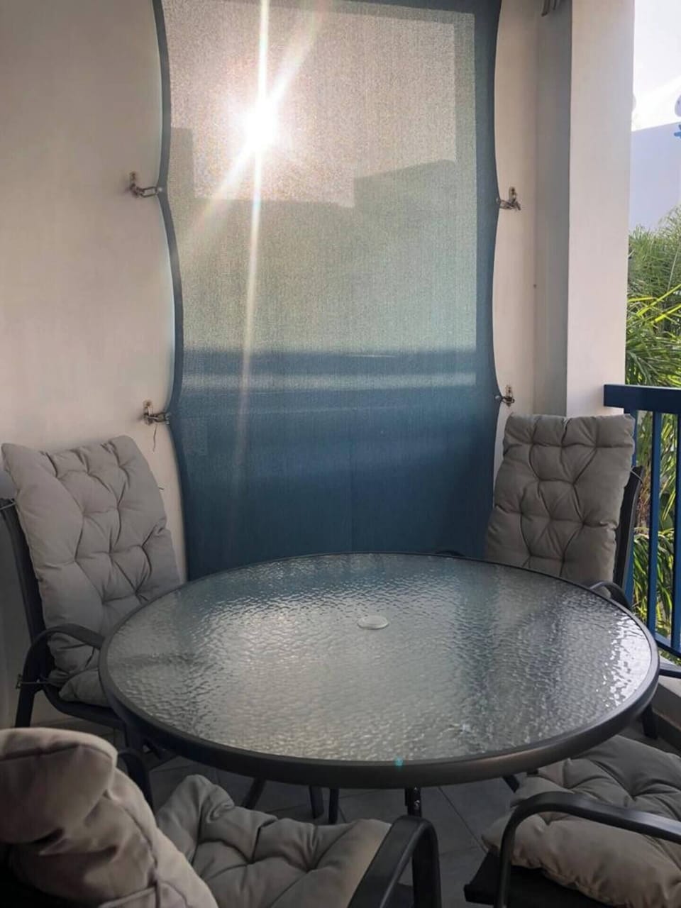  table and 4 chairs with nice view over the pool watching the sunset dining