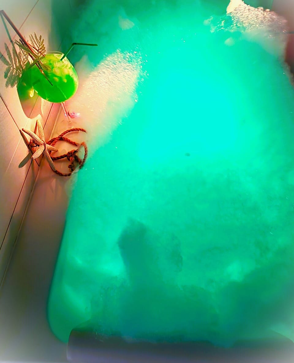 Opulent body therapy spa bath with tranquil LED lighting.
