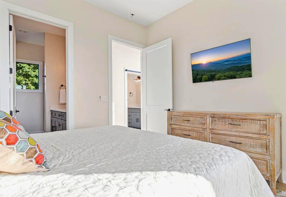 The primary bedroom’s en-suite bathroom adds a touch of luxury with its modern fixtures and spacious design.