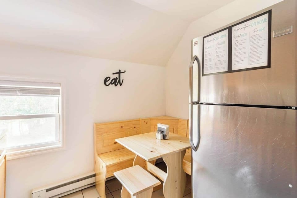 Cozy Dining Area with Stainless Steel Refrigerator