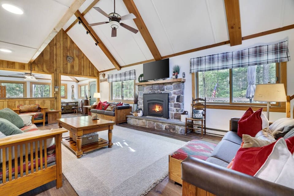 Large Living Room with 3 sofas(1 is a pullout), one of three fireplaces, this one is a gas fireplace, & 50` smart TV