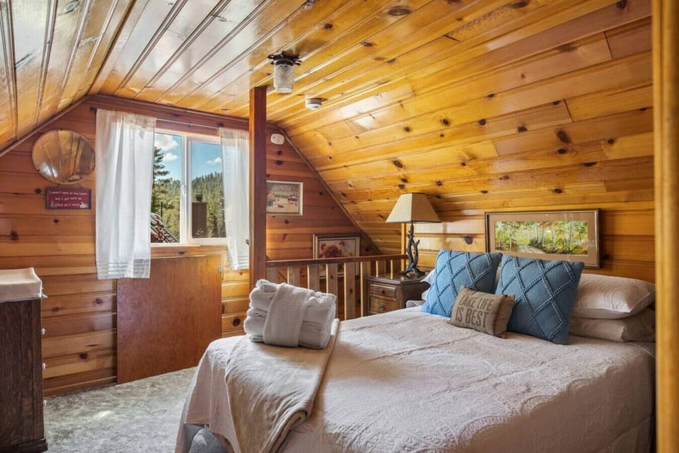 Upstairs there is a large 3/4 partitioned bedroom, with a full size bed, and a Queen bed with twin trundle.