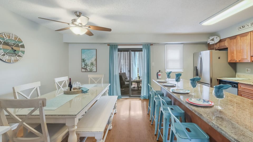 Kitchen with 4 stools at large island and dining area seats 6.