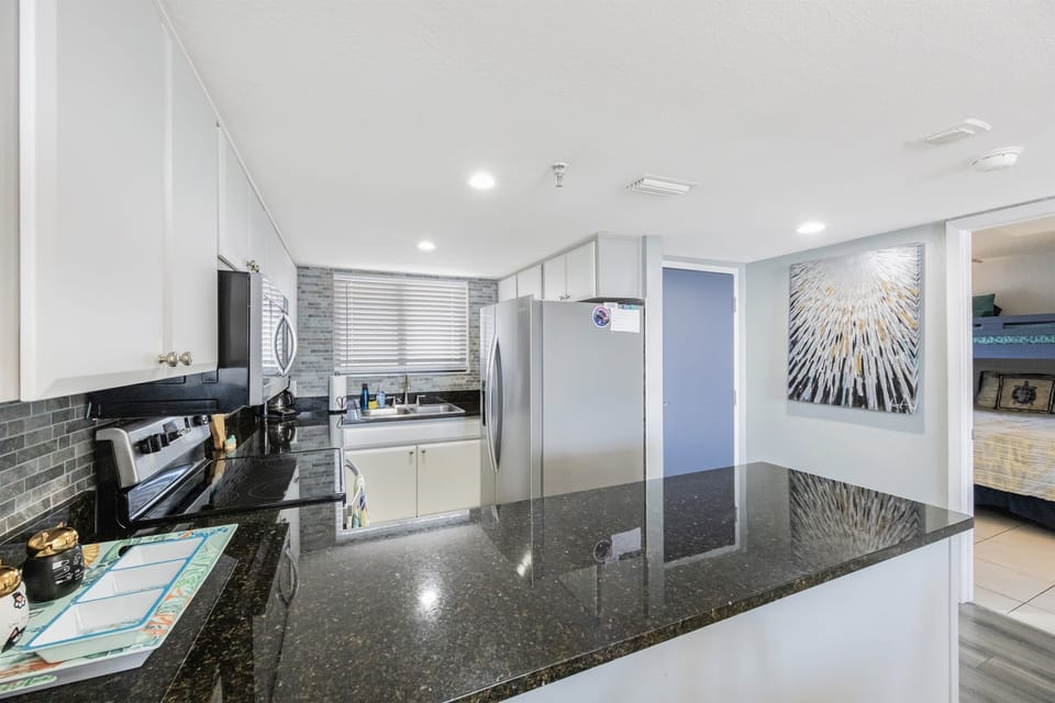 The kitchen and guest bedroom entry