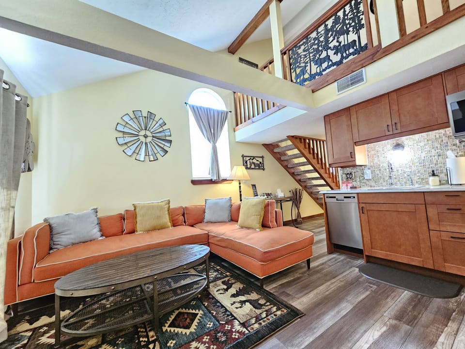 Living room and huge, comfortable sectional, cabin decor, & rustic coffee table!