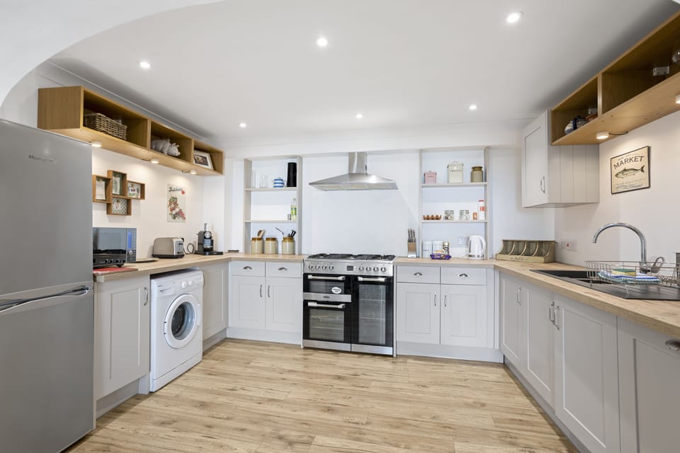 Open modern fitted kitchen leading to dining area