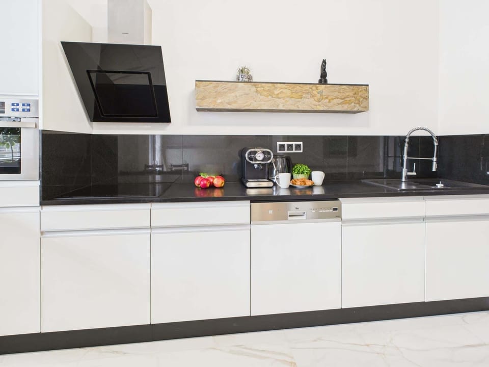 Bright kitchenette with functional appliances.
