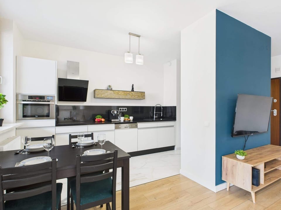 The dining and living areas connected seamlessly, featuring a mix of dark and light tones for a balanced aesthetic.