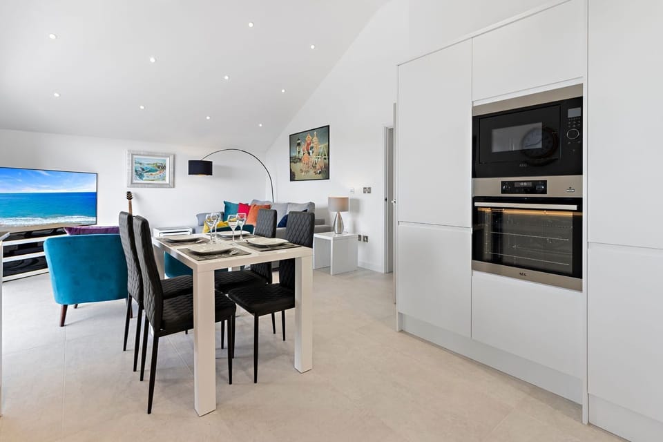 Stylish living room, dining area and kitchen