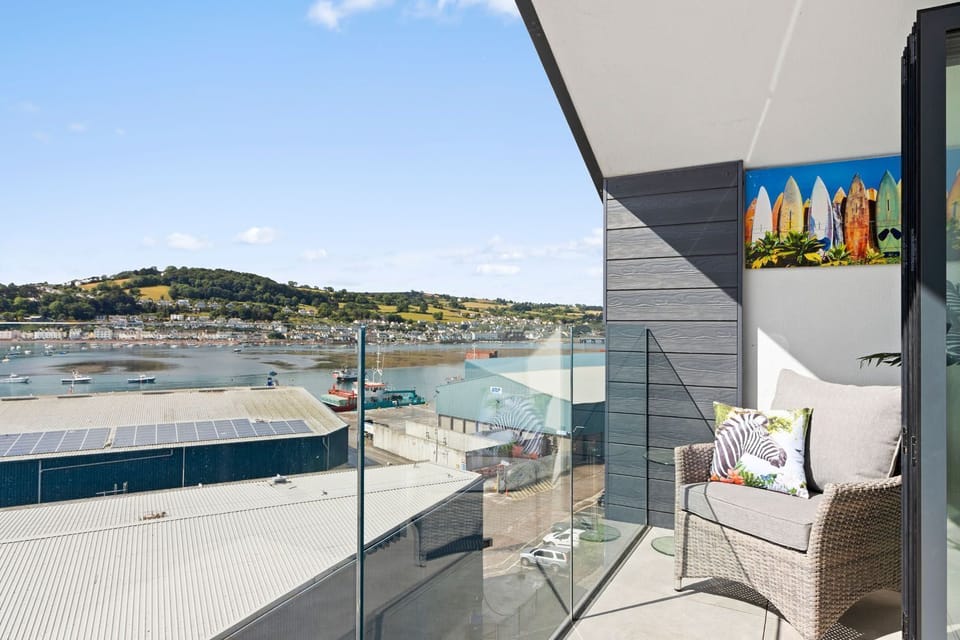 Spacious balcony with seating areas and views of the estuary and out to sea