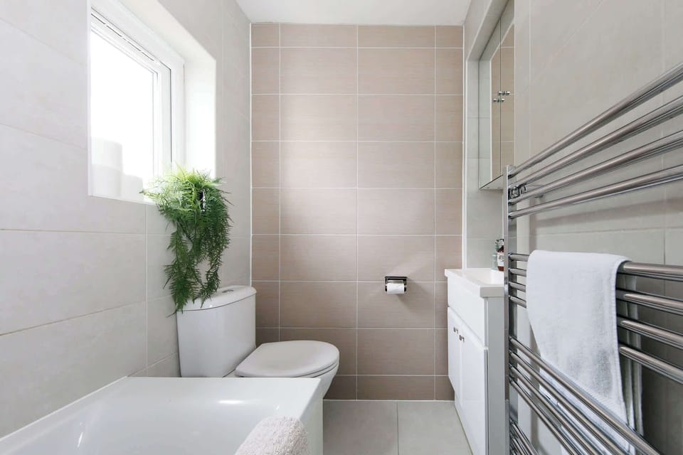 A family bathroom has towels and toiletries for all guests.