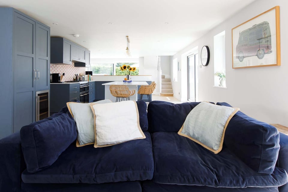 Luxurious sofa and pillows in the kitchen/living space.
