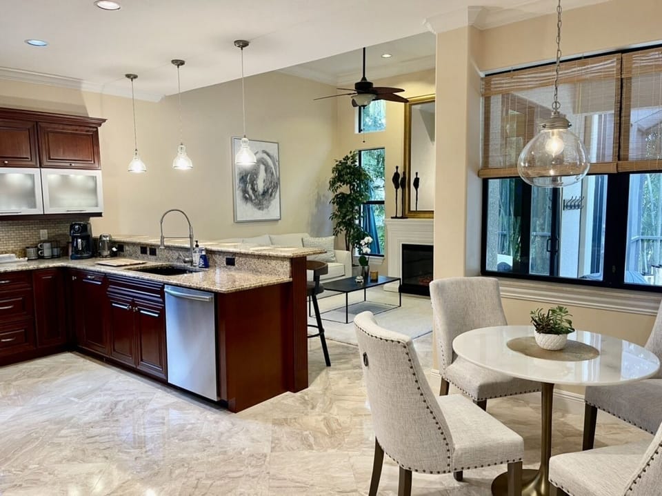 Kitchen area with 4 bar chairs , breakfast area , family room 