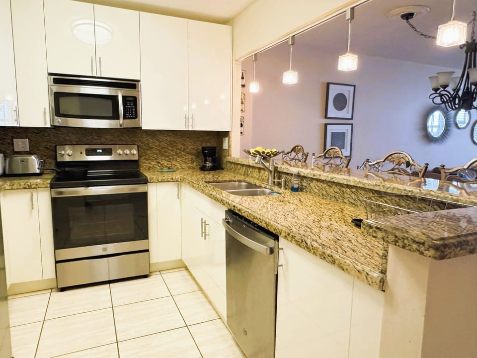 full kitchen with dishes, utensils, pots and pans, coffee maker, juicer, toaster