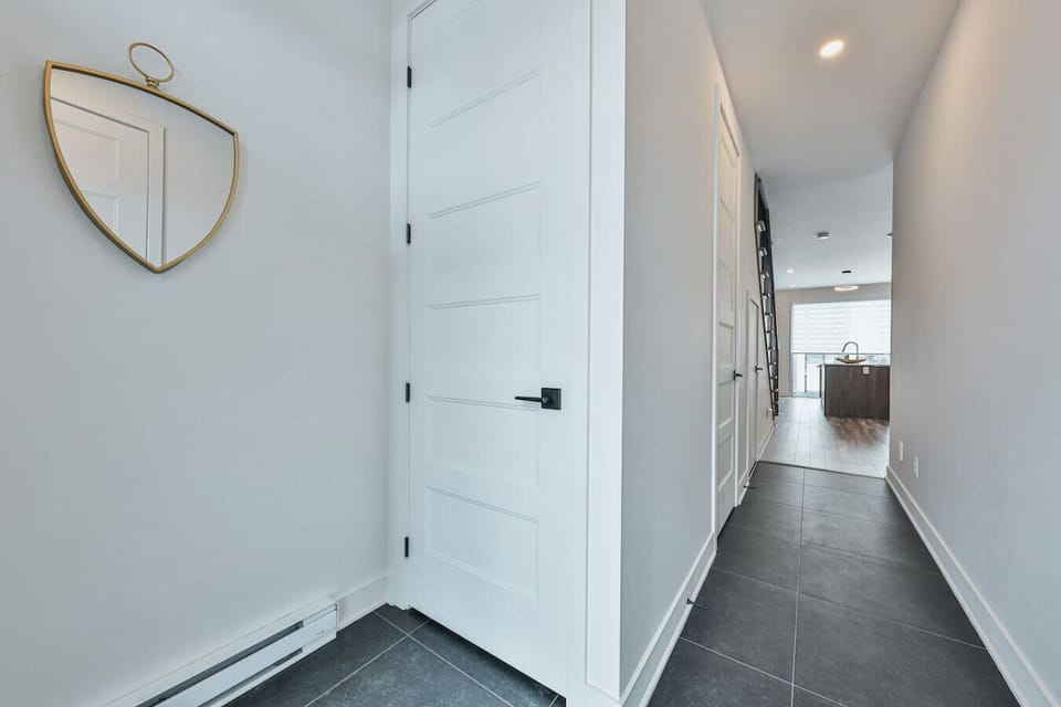 Upper-level hallway connecting the bedrooms to the open kitchen and living area.