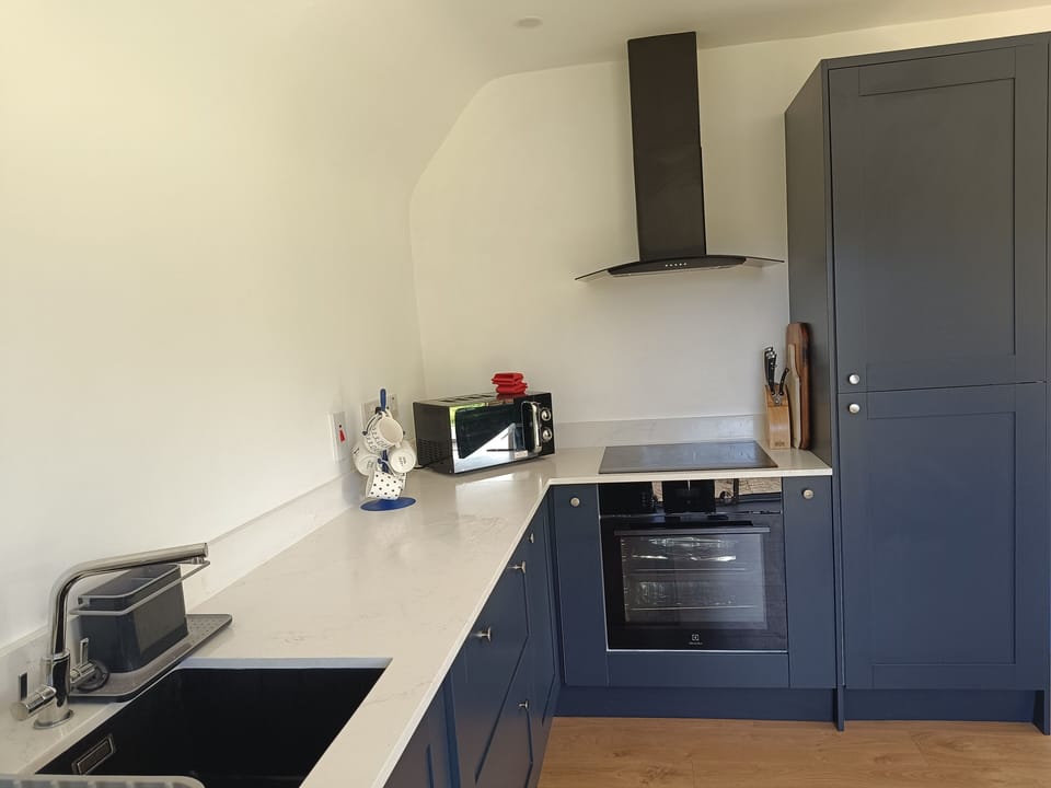 Microwave, induction hob, fridge/freezer.