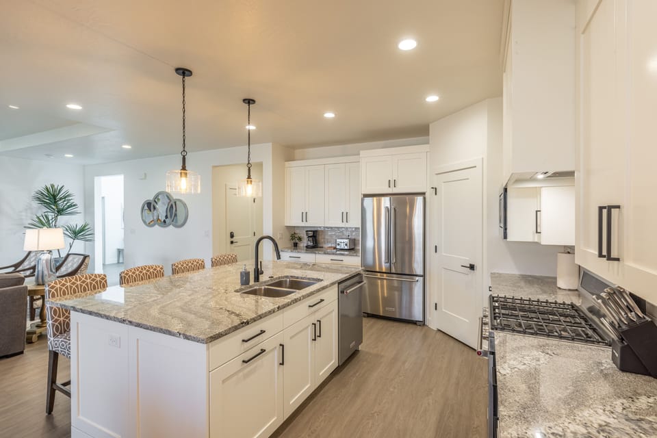 View of Kitchen - The Kitchen is complete with everything you will need for meal preparations including pots, pans, baking dishes, plates, cups, silverware, cutlery, and an assortment of cooking utensils.