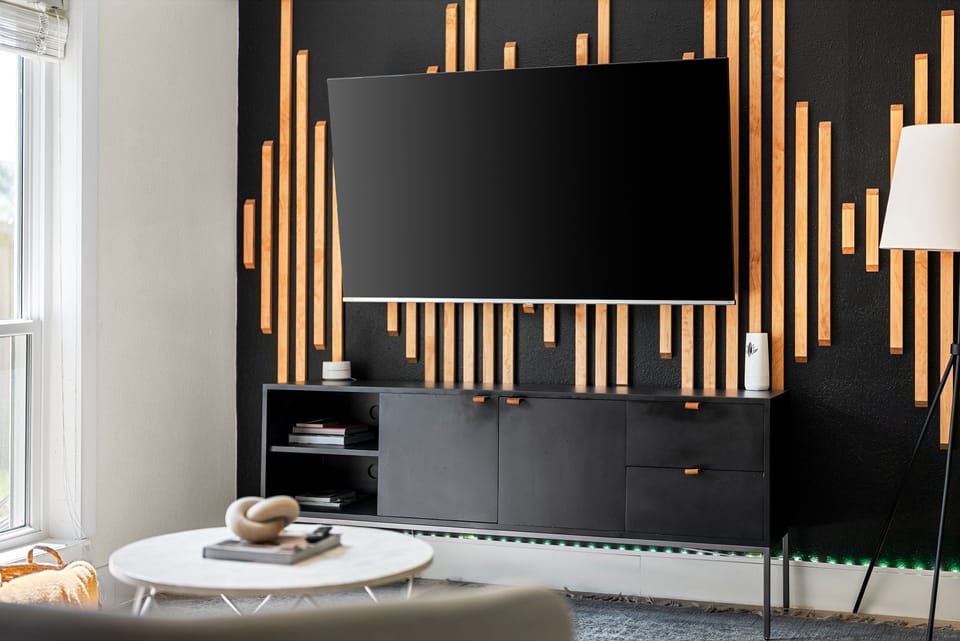 The TV complements the rest of my room decor, adding a modern touch to the space.