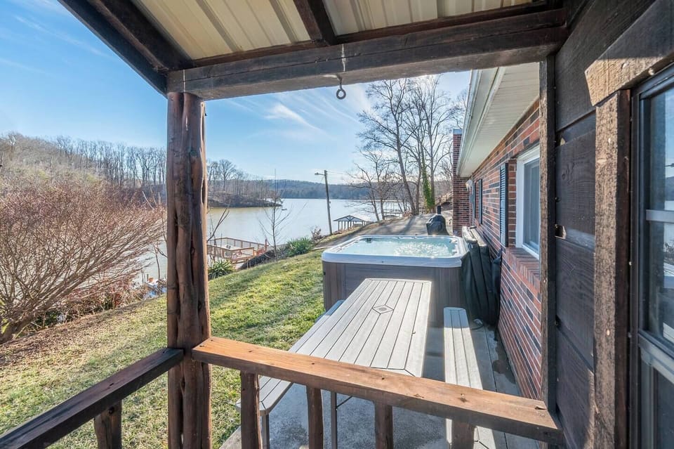 Soak in the private hot tub with breathtaking lake views!