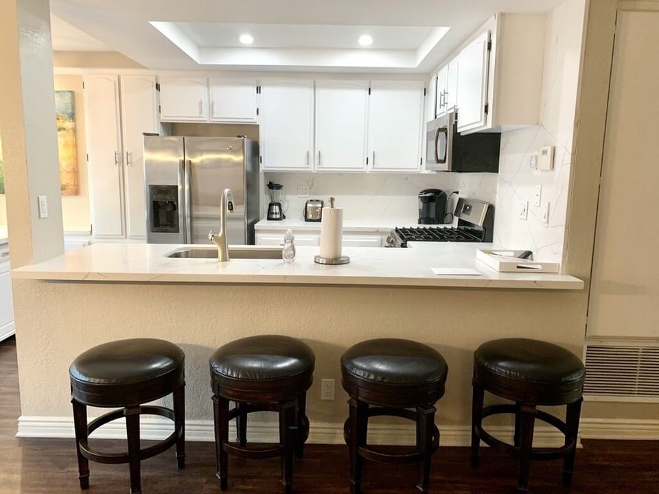 New stove, sink, faucet and Keurig coffee maker with 4 leather swivel barstools