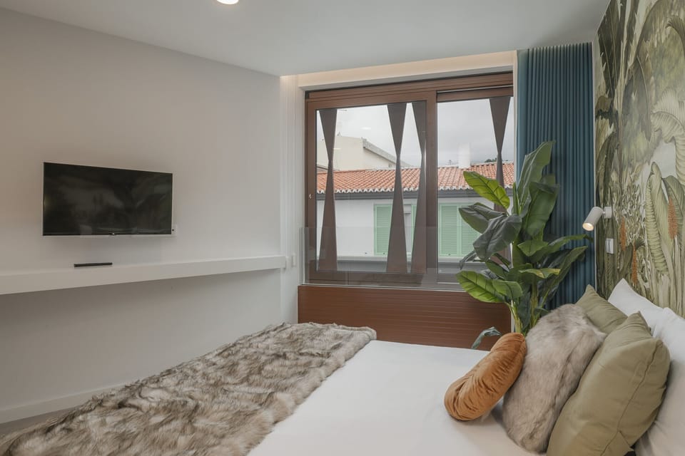 Bedroom with a double bed and a TV