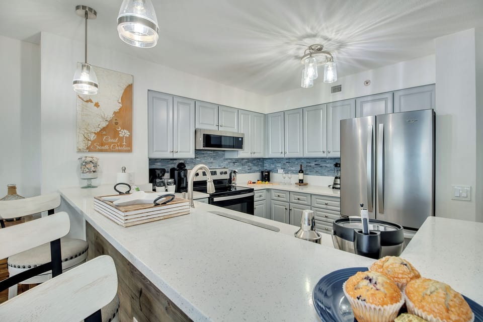 Your gourmet kitchen awaits with stunning quartz countertops, modern stainless appliances, and coastal-inspired touches perfect for creating memorable meals.