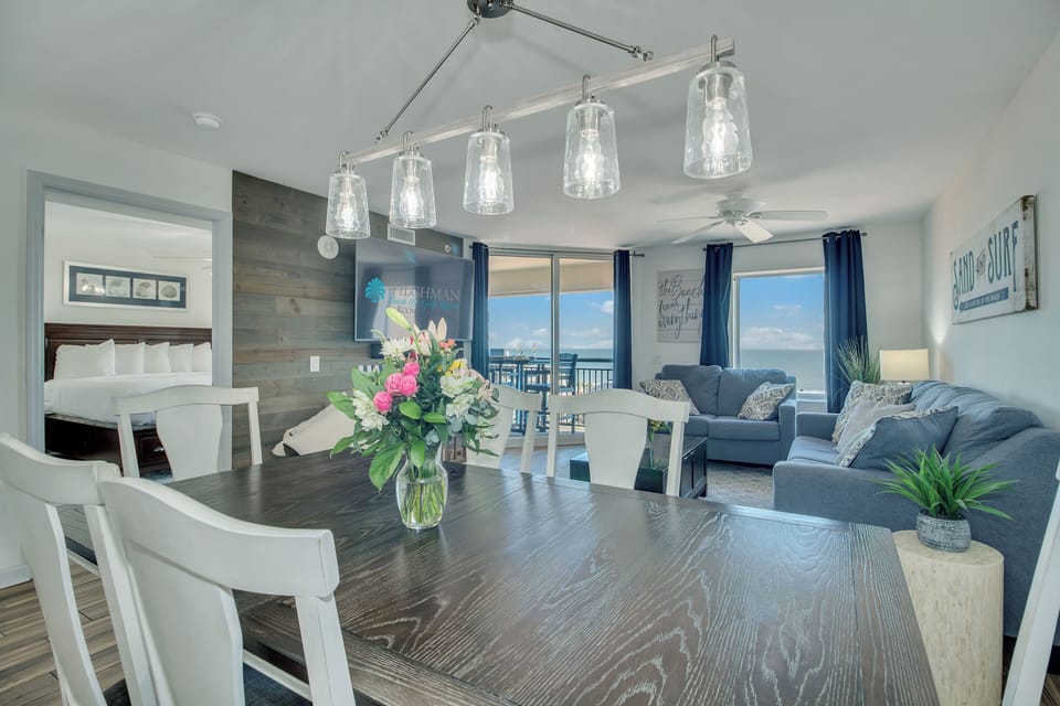 Unwind in your stylish open-plan space where coastal blues meet modern comfort, complete with stunning ocean views through floor-to-ceiling windows.