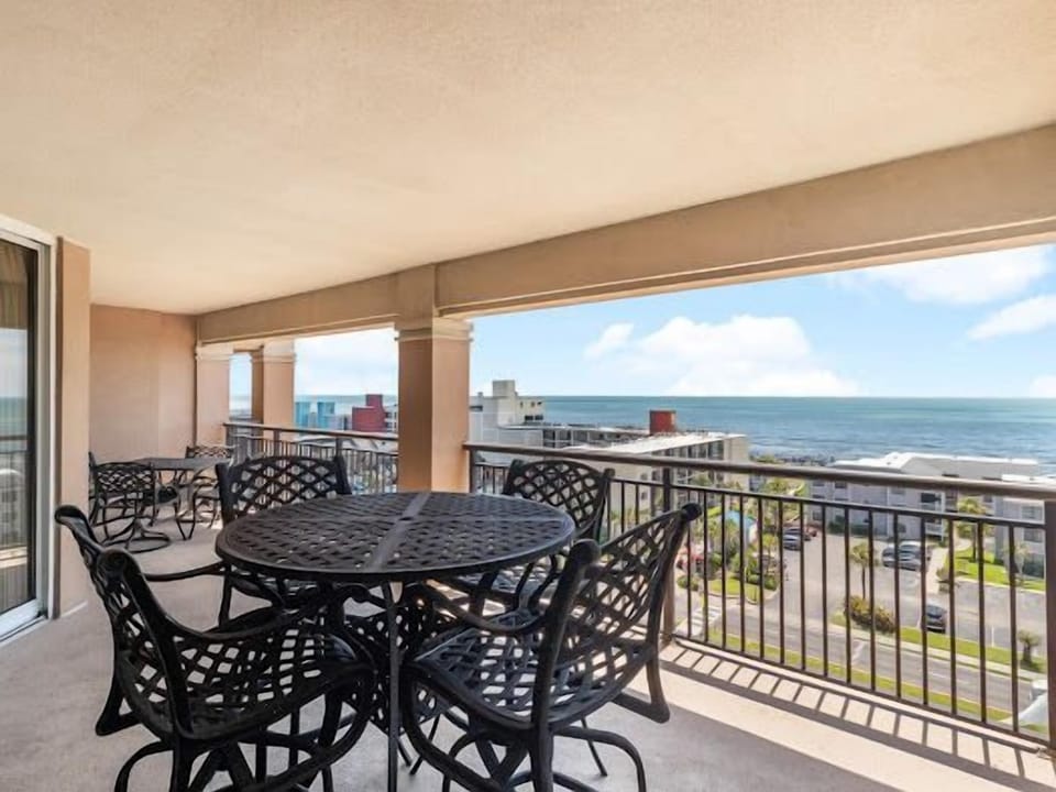 Enjoy your morning coffee at this spacious balcony with stunning ocean views and comfortable seating for memorable meals.