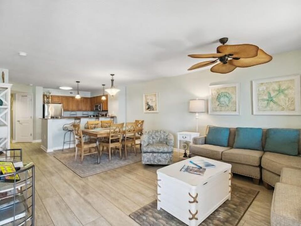 Unwind in your spacious open-concept retreat where coastal charm meets modern comfort, featuring a fully equipped kitchen and inviting living space perfect for relaxing.