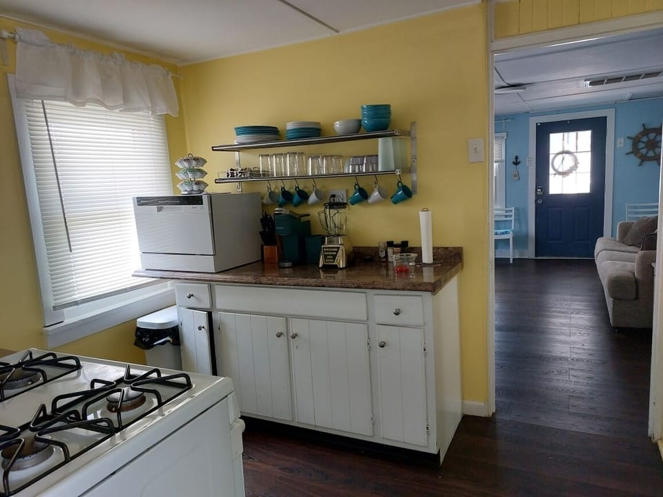 Counter top dishwasher and well appointed kitchen.