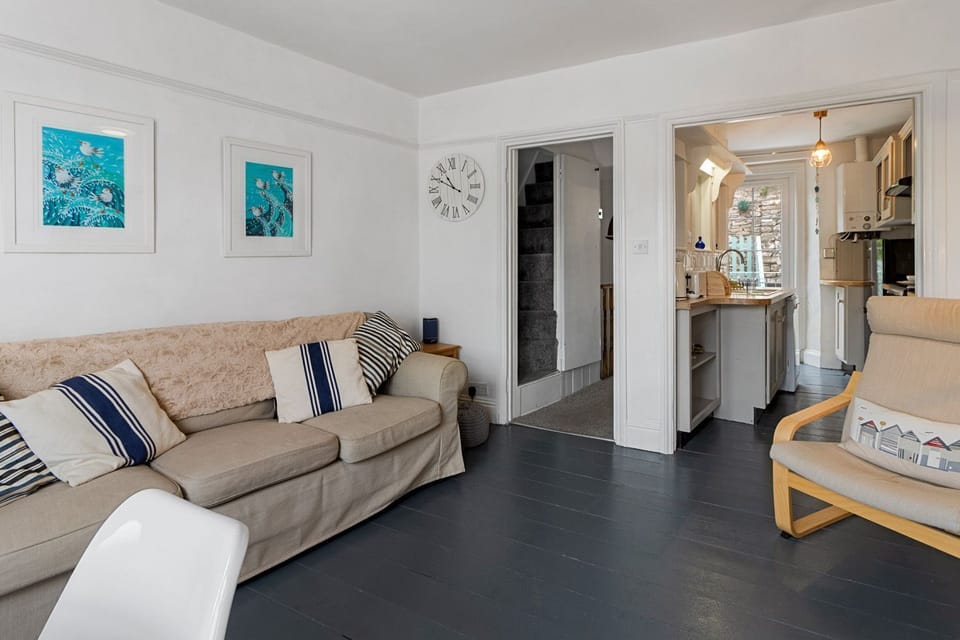 Stylish lounge with comfortable sofas and dining area in the bay window with views of the harbour
