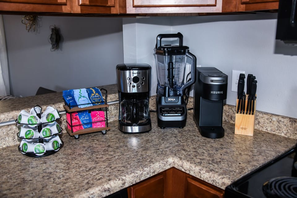 Kitchen complete with cookware, drip and Keurig coffee makers, dishes, and more 