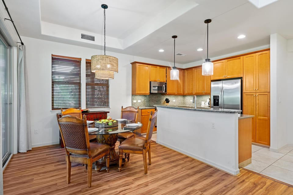 Kitchen and dining space feature granite countertops and plenty of cabinet space.