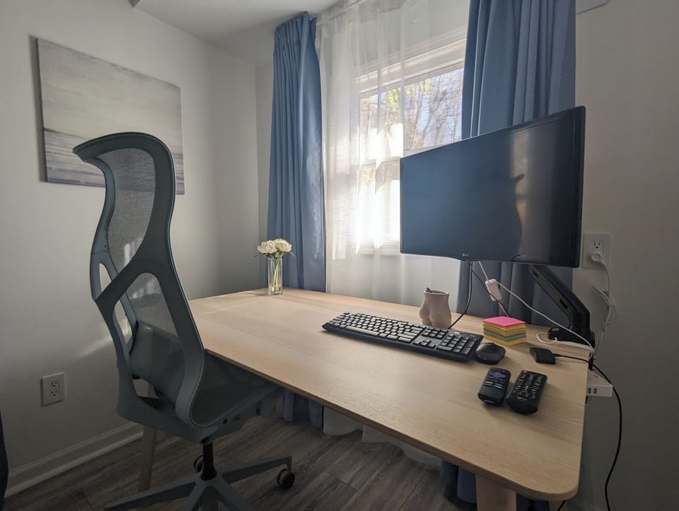 Workstation with comfortable chair, monitor, keyboard and mouse.