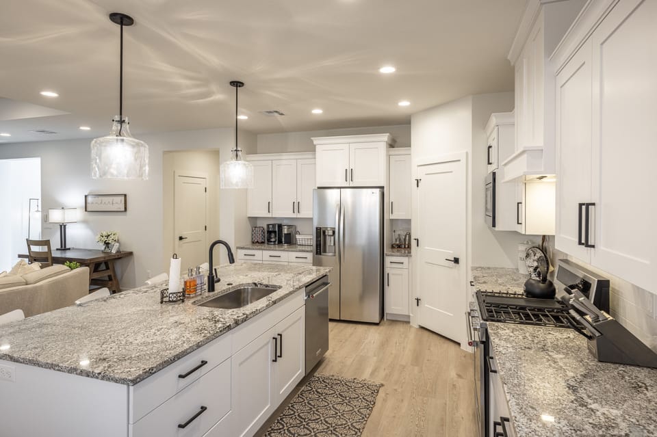 Kitchen Side View - The Kitchen is complete with everything you will need for meal preparations including pots, pans, baking dishes, plates, cups, silverware, cutlery, and an assortment of cooking utensils.
