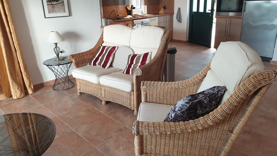 Lounge area with a double sofa and 2 single arm chairs, and coffee tables